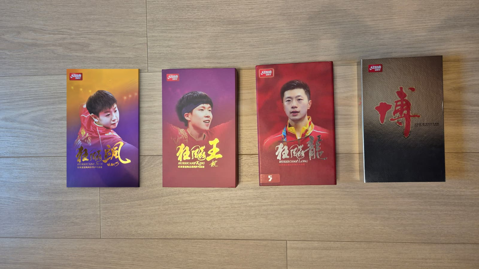 DHS Sun Yingsha, Wang Chuqin, Hurricane Long 5 and Fang Bo B2X blade boxes side by side