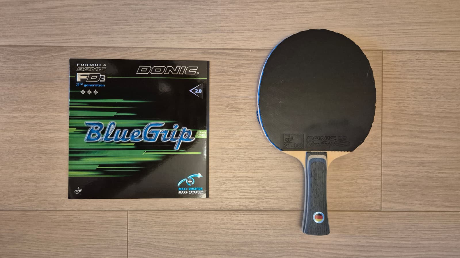 Donic BlueGrip S2 rubber packaging next to a Donic Appelgren WC 89 blade with the rubber applied