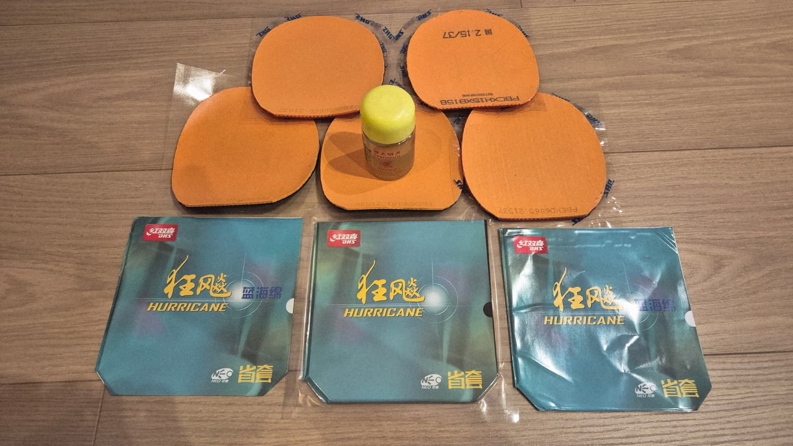DHS Hurricane 3 Neo provincial and commercial versions with orange and blue sponge rubbers and booster